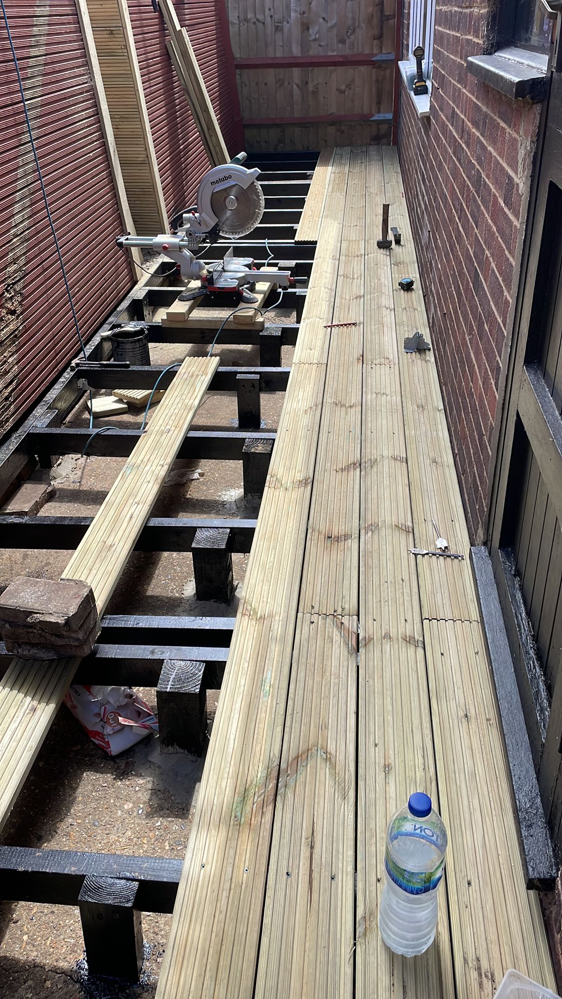 Timber decking being installed on a restored supporting frame