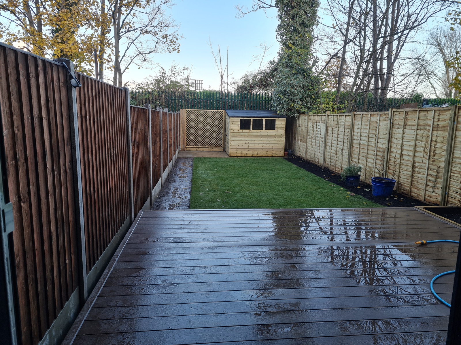 The same garden after transformation, with new fencing, lawn, shed and decking