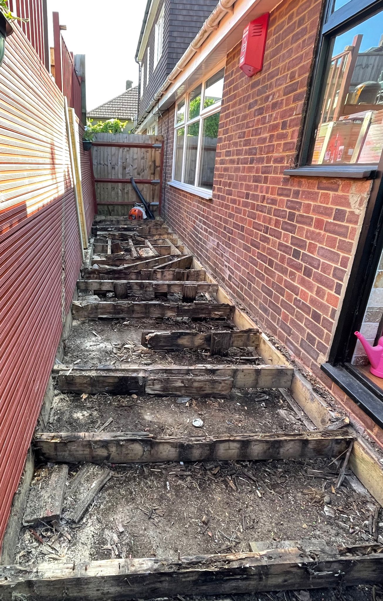 Side garden after the old damaged decking boards were removed